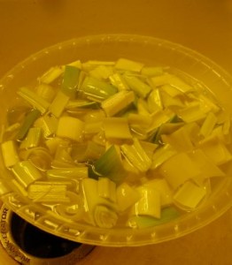 Washing leeks in cool water to remove grit